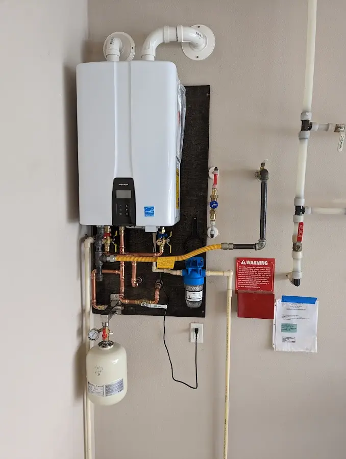 Professional plumber installing copper piping in a Camp Swift home